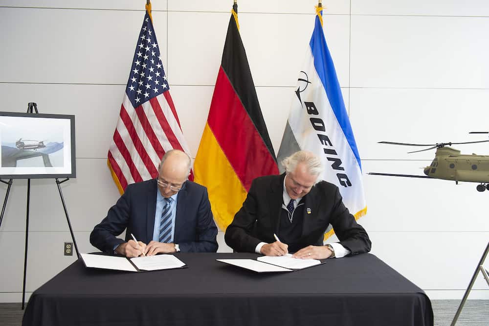 Torbjorn (Turbo) Sjogren, Vice President, Boeing Global Services, International Government & Defence and Wolfgang Schoder, General Manager of Airbus Helicopters in Germany, signing the MoU in Philadelphia