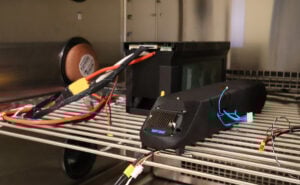 The prototype battery (left) and auxiliary battery (right) are set up for testing in the thermal chamber.